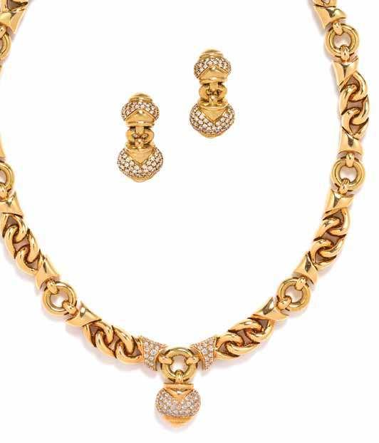 531 532 533 531 a 18 Karat Yellow Gold and Diamond Demi Parure, Bulgari, consisting of a polished geometric and curb link bracelet surrounding a central heart shape pendant pave set in the pendant