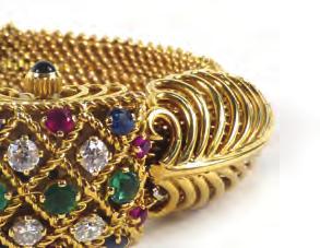 sapphire set winder behind a hinged lattice work cover set three emeralds, four