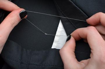 End at the back and tie a knot with the working thread and the tail you left at the start.