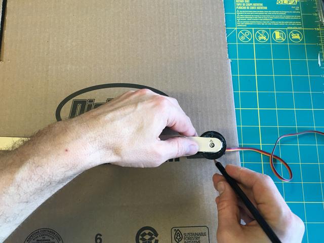 Use a hobby knife to cut out the servo opening.