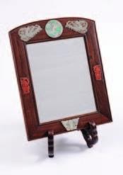 428A 429 428A A Chinese hardstone mounted hardwood mirror of arched rectangular form, the frame set with six plaques carved with a