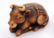 100-200 433 A Japanese carved and stained netsuke in the form of a grotesque mask, 6cm, and one similar, signed 5cm.