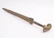 449 449 A Lourestan bronze sword, with 56cm. double edged and fullered blade, having a traditional grip and pommel, overall length 81cm. 250-350.