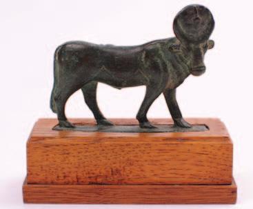 between its horns, the figure 8.5cm. long, mounted on an associated oak plinth.