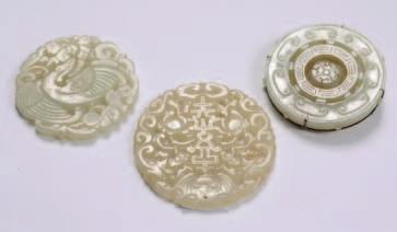 461 460A 463 460A A Chinese carved jade circular pendant with pierced flowerhead and scroll decoration, 6.5cm.