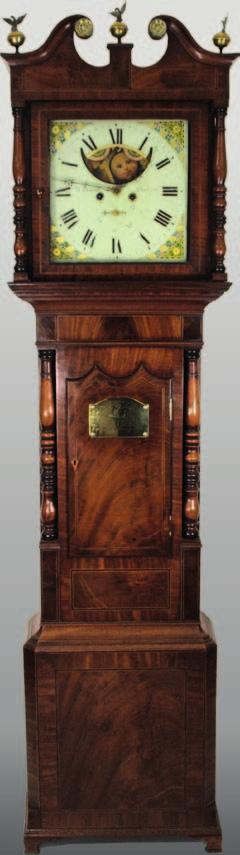 Dunville, Stockport, the mahogany case with ebony and satinwood stringing to the trunk, door and base, canted corners to the base, the trunk with matchbox panels above and below the door, turned