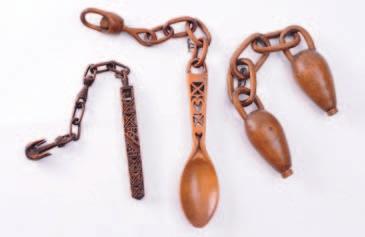 200-300 417 A Welsh treen love spoon with lantern stem containing two balls, on a chain, a pair of love vessels each 12cm.