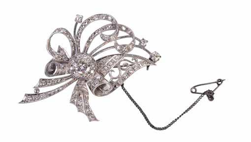 Lot 415 18ct white gold brooch of a floral and ribbon design set with solitaire brilliant cut diamond of approximately 1.