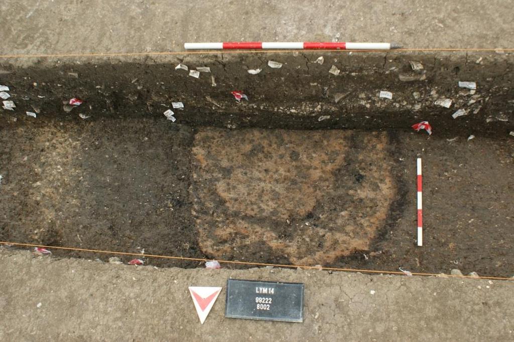 The discovery of an in situ hearth 66 cm below the surface of the contemporary ground level in the E-W sondage indicates that these phases of infilling were punctuated by periods of stabilisation
