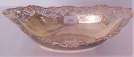 250 CAST SILVER OVAL BOWL WITH FRET WORK & FRUIT DECORATION OF ASPREYS OF LONDON 251 9CT RING 252 DECORATIVE SILVER HIP FLASK 253 INDIAN SILVER CIGARETTE CASE 254 SILVER INGOT, CHARM BRACELET & A 9CT