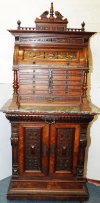 149. Edwardian carved walnut marble topped Dental Cabinet fitted with a series of pull out Drawers,
