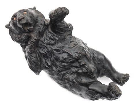 * 500-600 621 622 621 A Japanese bronze study of a bear lying on its back with glass inset
