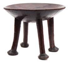 641 641 Kamba Tribe, (Kenya, East Africa) a carved hardwood stool of circular form raised on four legs terminating in pad feet, 37.