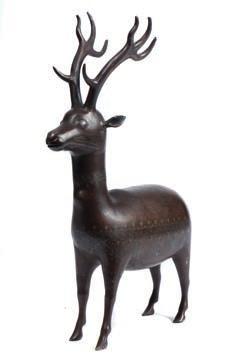* 200-300 643 643 A 19th century Persian steel and silver figure of a stag with inlaid Arabic decoration of scrolls and cartouches