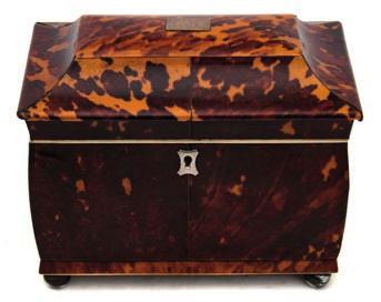 * 120-180 676A 677 677 A 19th century blonde tortoiseshell tea caddy of sarcophagus outline, the shallow domed hinged lid enclosing two lidded
