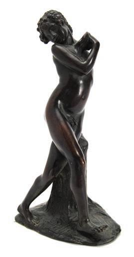 706 706 After Ernst Seger a bronze study of Bacchus as a boy the youth leaning against a tree