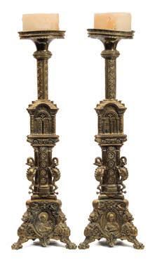 * 200-300 718 718 A large pair of 19th century brass candlesticks in the Italianate style, the circular drip trays on a foliate decorated columns and triangular shaped