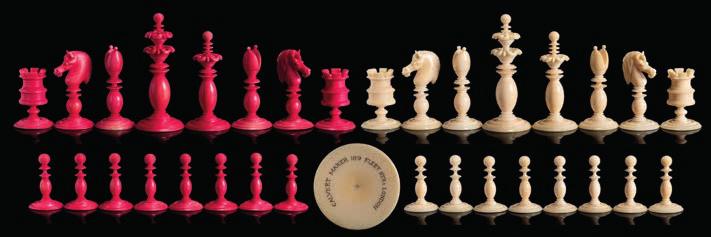 587 587 An Indian bone Barleycorn pattern chess set one side stained red, the other left natural, the king 11.5cm.