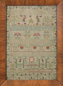 * 200-300 598 598 A mid 18th century needlework sampler with banded verse, flowering shrub