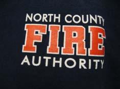 inch white block letters, Job Shirt solid dark blue, collared, ¼ zip. Optional last name and Station Number opposite logo, upper right breast, DCFD in Block letters White with Red Trim on back.