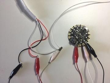 Then attach the free red wire coming from strip #1 to VOUT and the free black wire to G on the Circuit Playground.