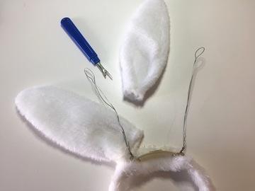 Use a thread ripper to carefully remove both ears from the headband.