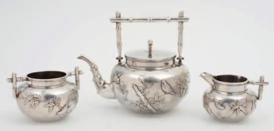 118 118 A Chinese silver three piece tea service, maker Wang Hing & Co, Hong Kong, the teapot with rectangular bamboo shoot handle, the body decorated with finches amongst bamboo, with similar