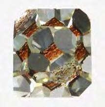 DIAMOND With Circular Brown or Green Radiation Stains Green and brown stains are occasionally seen on both rough and faceted diamonds.