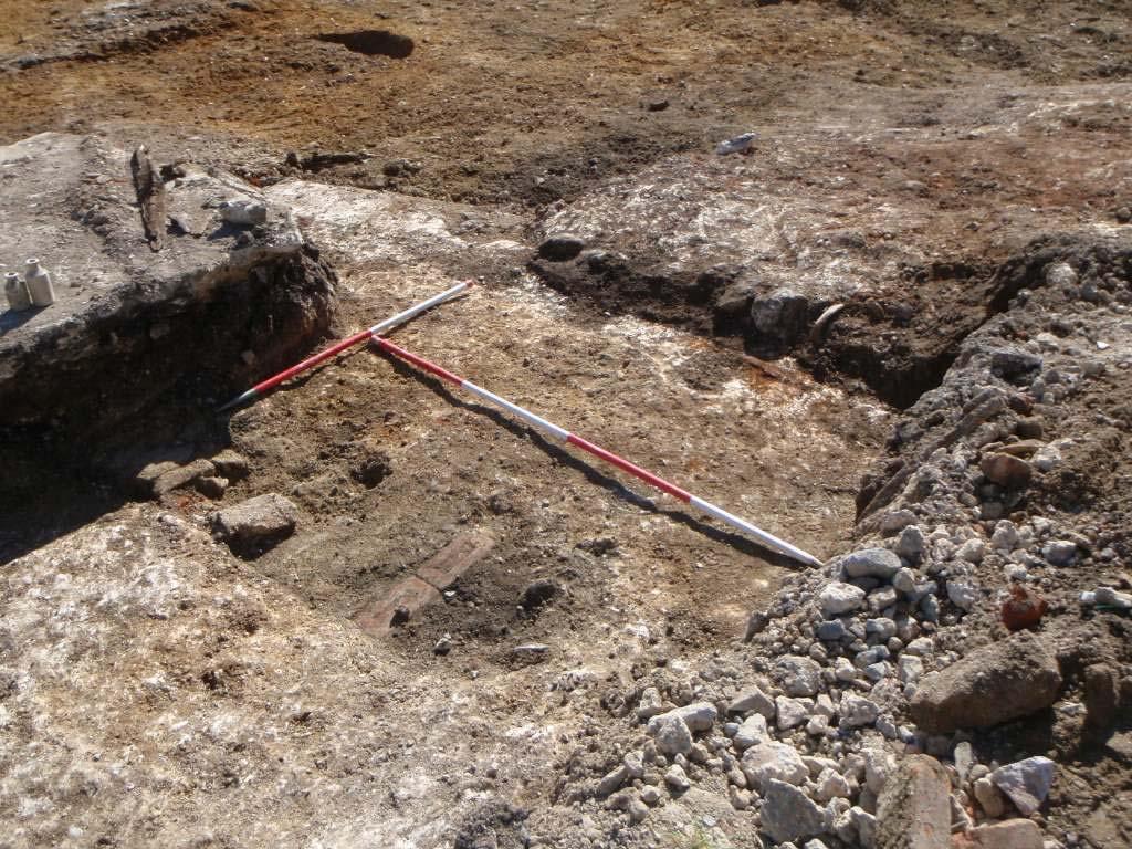 The fireplace was cut through a probable medieval clay floor surface that was burnt hard in places.