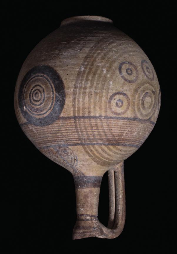 20 34. Cypriot oinochoe in Bichrome Ware. The spherical body with narrow conical neck, double reeded arched handle from shoulder to trefoil lip.
