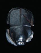 10 11 12 13 10. Egyptian haematite bull-headed scarab, the head with horns, the underside naturalistically rendered, the body pierced horizontally. Intact. Late Dynastic Period, c.664-330 BC.
