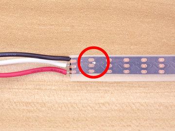Now we can prepare the NeoPixel strip by trimming off the connector. Leave the wire long by cutting as close as you can to the connector.