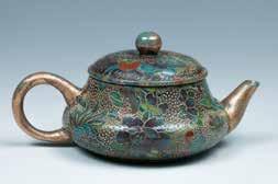 61 AN ENAMELLED YIXING TEAPOT AND COVER 加彩紫砂壶 Of overall conical form with a compressed globular lower body, the Zisha teapot painted with flowers and