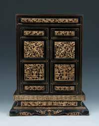 The box of rectangular form, the door frames mounted with a metal handle, enclosed an interior painted with golden decorations. 29cm x 44cm x 12.