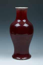 29 A RED GLAZE VASE,QING 清红釉赏瓶 The red glazed vase of overall tapered form, with a globular body that raising