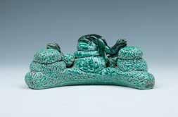 31 A GREEN GLAZE BRUSH REST, QING 清绿釉雕瓷笔架山 The green glazed brush rest is mimicking two beasts resting and climbing