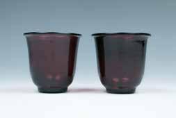 十九世纪红色料器杯一对 A set of two Peking glass wine cups, of a deep bell-shaped body, stands on a tall foot rising to a