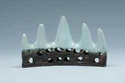 5cm 38 A CELADON GLAZE BRUSH REST 青釉雕瓷笔架山 The brush rest modeled in the form of a mountain, the upper part covered with