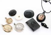 157. A small collection of mourning jewellery, to include a jet oval locket with porcelain mount, a bog oak carved