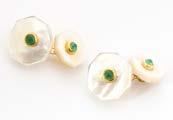 214. A pair of onyx and emerald cufflinks, carved black onyx centred with cabochon emerald united by silver gilt