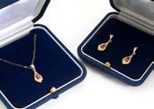 A contemporary 9ct gold ruby and diamond set pendant, with matching earrings in fitted case 60-80 283.