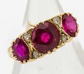 A contemporary 18ct white gold ruby and diamond dress ring, the oval mixed cut ruby in colette setting surrounded by