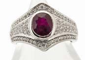 An Edwardian 18ct three stone ruby and diamond chip ring, the central mixed cut ruby, a synthetic replacement,