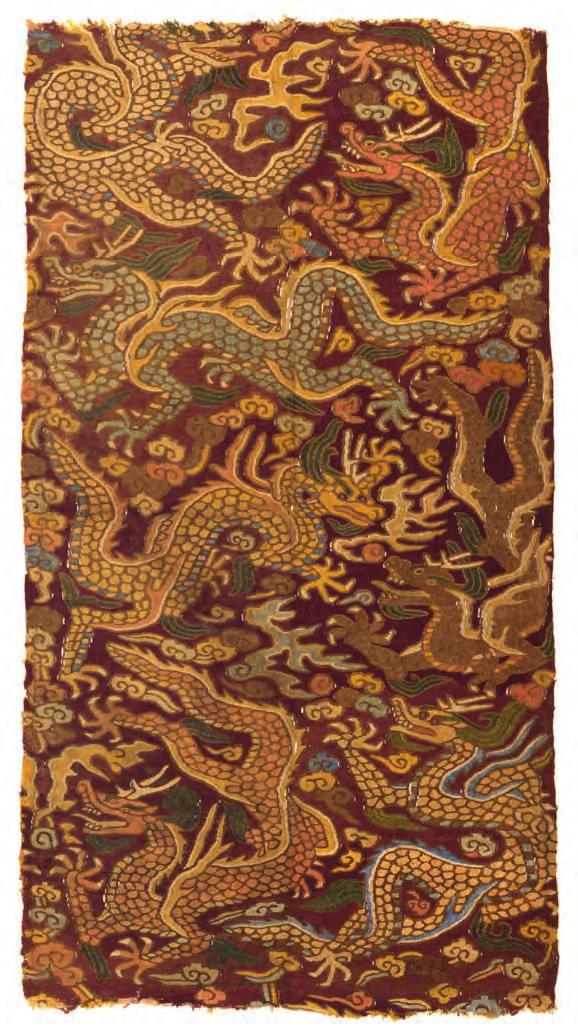 1 A silk kesi panel, woven with a design of seven dragons chasing flaming pearls amongst clouds on a purple ground.
