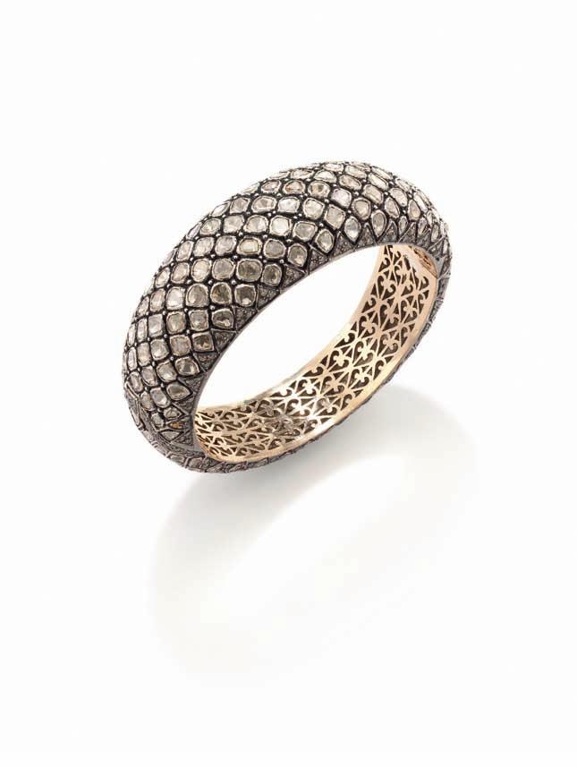 241 239 240 239 A Diamond Snakeskin Bangle The graduating hinged bangle set throughout with lasque-cut diamonds and circular-cut diamond accents, mounted in silver and gold, diameter 2 1/3 inches.