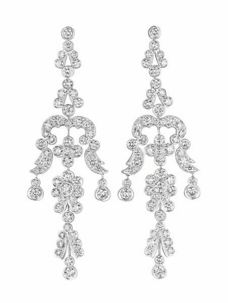 138 138 A Pair of Diamond Ear Pendants Each of chandelier design, decorated by circular-cut diamond florets, enhanced by circular-cut diamond scrolling foliate links, mounted in 18K white gold,