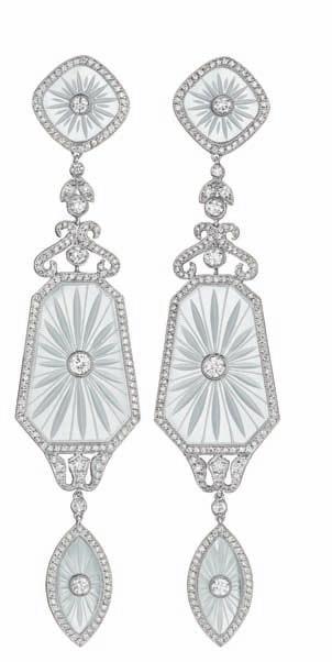 167 167 A Pair of Diamond and Rock Crystal Ear Pendants Each suspending two carved crystal plaques, centering on a colletset circular-cut diamond, within a pavé-set diamond surround, to the