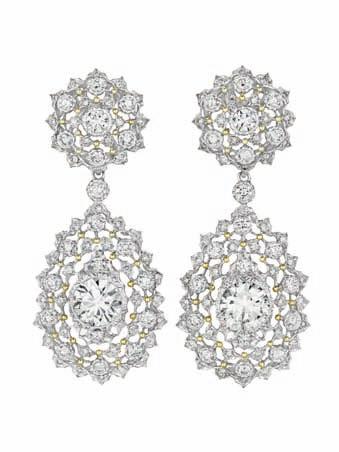 178 179 178 An Important Diamond and Gold Bracelet BUCCELLATI The textured and engraved white gold hinged cuff, centering three openwork circular-cut diamond foliate panels, further enhanced by