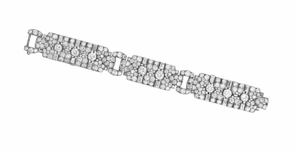 Estimate $7,000-10,000 PROPERTY OF A LADY 194 A Diamond Flower Brooch Designed as four pavé-set diamond flowers, centering upon old-cut diamonds, enhanced with circular-cut diamonds, extending