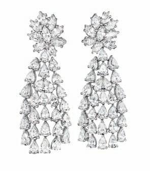 Estimate $9,000-12,000 208 A Pair of Diamond Ear Pendants Each designed as a pear-shaped diamond graduating cascade, suspending from a marquise-cut diamond cluster surmount, mounted in 18K white